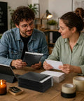 Two people discussing with 302 Pcs Trading Card Shipping Supplies Kit Ready To Ship With Heavy Duty Bubble Mailers And Card Sleeves on table.