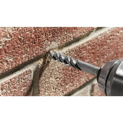 Close-up of a masonry drill bit, 3/4 in x 4 in x 6 in fast-spiral, drilling into brick.