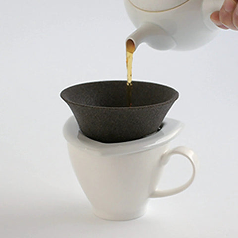 Japanese Ceramic Coffee Filter With Reusable Blue Dripper Stand And Eco Friendly Micropore Design For A Smooth Next Level Pour Over Brew That Truly Hits Different pouring coffee into a white mug.