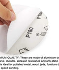 Close-up of a 6-inch PSA sanding disc being peeled from its paper backing; aluminum oxide abrasive, P180 grit.