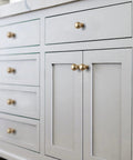 Close-up of furniture with Six Pack Zinc Alloy Drawer Knobs 0.94 Inch Diameter Champagne Bronze Cabinet Knobs in modern style installed.