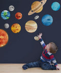 Child reaching towards Solar System Wall Stickers For Kids Large Planet Wall Decal Space Room Decor For Bedroom Classroom Playroom Nursery Non Toxic Vinyl With Matte Finish Eco Friendly Durable Educational Gift Idea