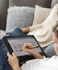 Child using No Plug Needed Jumbo Digital Stylus Pen With Eraser For Touchscreens on a tablet, seated on a sofa.