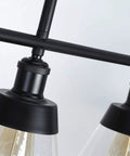 Close-up of Dope 3 Light Farmhouse Black Kitchen Island Pendant Light With Clear Seeded Glass And Adjustable Rods showing detail.