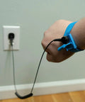 Person wearing Anti Static ESD Wrist Strap Kit with blue wristband and black coil cord, plugged into wall for safe electronics handling