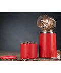 Portable Manual Coffee Grinder And Brewer With Built In Bean Storage All In One Travel Coffee Cup For Camping And Road Trips showing red grinder and bean storage.