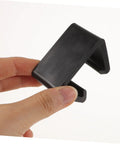 Close-up of a black clip from Outdoor Sofa Clips 12 Pack For Sectional Couches And Rattan Furniture, Windproof Connection Fasteners.