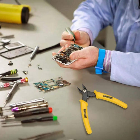 Technician using micro cutter flush cutter with angled jaws for electronics assembly.