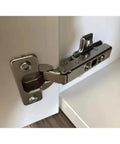 Close-up of a cabinet door hinge from the 8 Piece Cabinet Hinges Set with Straight Arm Full Coverage Soft Close Wardrobe Doors Adjustable Hardware.