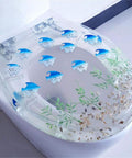 Super Slick Low Drama Auto Closing Toilet Seat With Silent Drop Lid And Transparent Fish Motif Universal Fit For Oval Round Or Square Bowls Heavy Duty Resin For Your Clean Bathroom Glow Up with blue fish design.