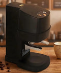 Heavy Duty Automatic Coffee Tamper With Adjustable Pressure Dial For Home Baristas And Specialty Shops Black Digital Espresso Press Tool on a wooden table.