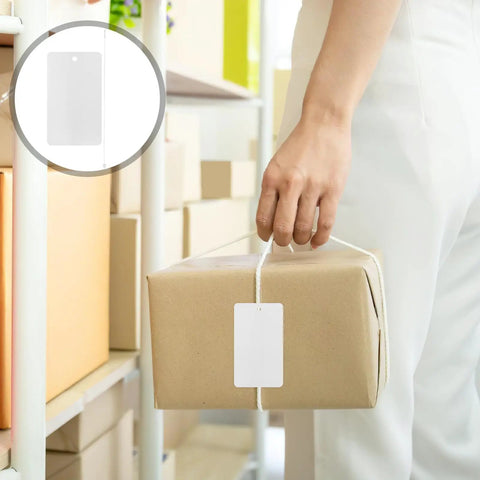Person holding a package with a blank white PVC hanging tag with lanyard waterproof 100 pcs for jewelry display labels.