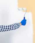 Person using Pro Grade Paint Roller Kit With Solid Frame And Click Swap Sleeves For Flawless Wall Painting on a wall.