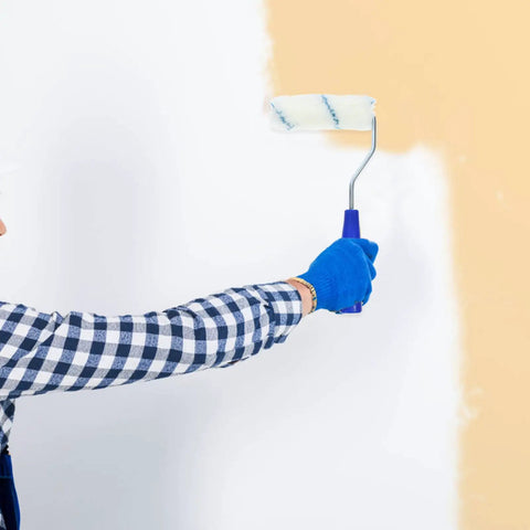 Person using Pro Grade Paint Roller Kit With Solid Frame And Click Swap Sleeves For Flawless Wall Painting on a wall.
