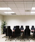 Conference room with long table and chairs, ceiling equipped with Emergency Battery Backup for Fluorescent Ballasts, T8 Compatible.