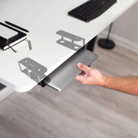 Universal Under Desk Laptop Mount With Adjustable Tablet Brackets For Hidden Computer Docking Station, holding a laptop.