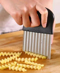 Close-up of crinkle cutter with upgraded stainless steel blades and black handle; kitchen tool for wavy French fries.