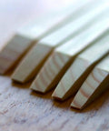 Close-up of wooden caulking tool edges from Caulking Tool Kit With Silicone Scraper And Sealant Smoother 5 Piece Ergonomic Caulk Finishing Set