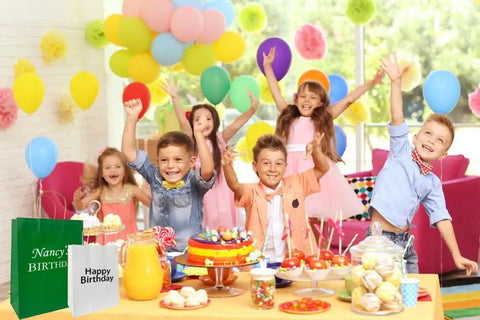 Children at a birthday party with balloons, cake, and Logo Ready Printed Kraft Paper Bags 100 Pack With Handles 12.6 X 4.3 X 9.8 Inches