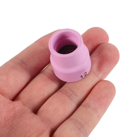 Rock Solid Pink Tig Welding Cups That Make Cleaning A Breeze, Sturdy Ceramic Nozzles showing a close-up in hand.