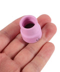 Premium Pink Ceramic Tig Welding Nozzle Cup held in hand, heat resistant for durable use in welding applications.