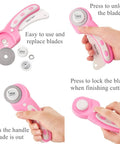 45mm Rotary Cutter Set With Ergonomic Handle, Five Extra Rotary Blades And Ten Replacement Blades in use, shown in pink.