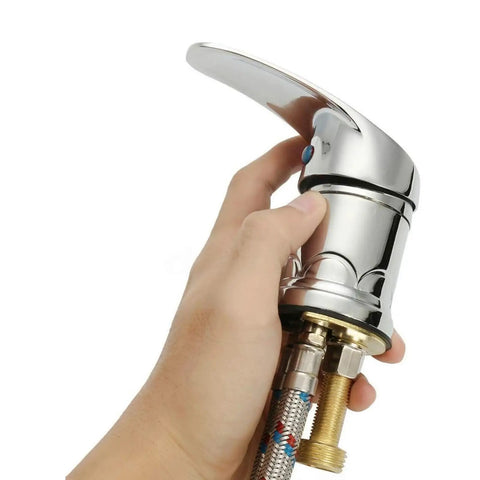 Hand holding Heavy Duty Zinc Alloy Shampoo Bowl Faucet Set Featuring Dual Hot And Cold Water Mixer With Flexible Spray Hose.