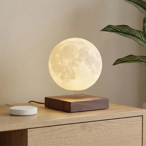 Lit Floating Moon Lamp With Magnetic Levitation And Spinning 5.9 Inch Moon Light on wooden base near plant for room decor.