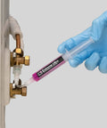 ERRECOM Extreme Ultra A/C leak-stop cartridge inserted into a copper HVAC line with 1/4 and 5/16 adapters