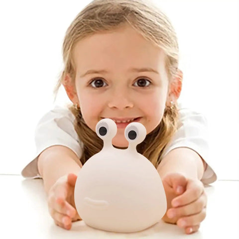 Child holding Slug Night Light Squishy Silicone Lamp For Nursery And Bedroom Cute Animal Bedside Glow BPA Free Safe Silicone Soft Warm Light For Breastfeeding Kids Teens Cozy Nighttime Ambience
