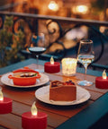 Three Pack Flameless Battery Operated LED Candles With Embedded Starlight String Lights on outdoor table with food and wine