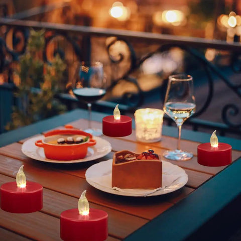 Three Pack Flameless Battery Operated LED Candles With Embedded Starlight String Lights on outdoor table with food and wine