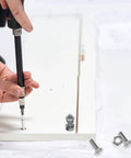 Person using 20 Piece M6 Stainless Steel Hex Bolts And Nuts Kit with 16mm thread length for mechanical fastening on white board.