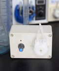 Front view of Peristaltic Liquid Dosing Pump For Lab And Aquarium Use 110 To 240 Volts, showing control knob and tubing connection.