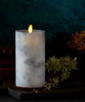 Realistic Marble Candles With Moving Flame LED Lights Battery Operated Unscented Remote Ready Not Included Create Cozy Vibes In Any Room 3.25 Inch Diameter 6.5 Inch Height with grey marbled texture and warm flickering light on a dark background