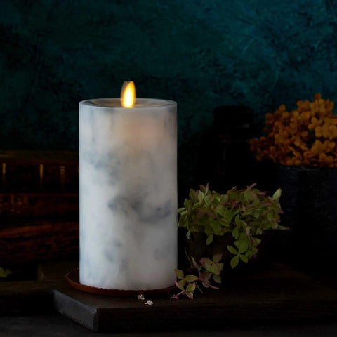 Realistic Marble Candles With Moving Flame LED Lights Battery Operated Unscented Remote Ready Not Included Create Cozy Vibes In Any Room 3.25 Inch Diameter 6.5 Inch Height with grey marbled texture and warm flickering light on a dark background