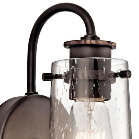 Braelyn 1 Light Wall Sconce With Clear Seeded Glass In Classic Pewter close-up of vintage industrial vanity lighting design