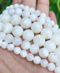 Legit Premium Natural White Pearl Shell Beads For Diy Jewelry Making With Awesome Iridescent Glow And Smooth Round Edges on a hand.