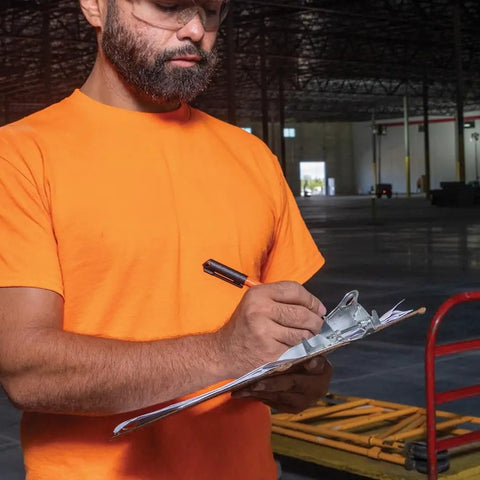 Man writing on clipboard with Ultra Fine Tip Permanent Markers Two Pack For Worksite Use With Professional Grade Ink