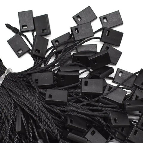 Heavy Duty Nylon Hang Tag Strings With Self Locking Quick Snap Binders 7 Inch bundle of black fasteners for garment labeling.