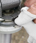 Close-up of hand using Pack Of 150 Cotton Shop Towels 12 By 14 Inches Absorbent Multipurpose Cleaning Rags for auto shop metal part