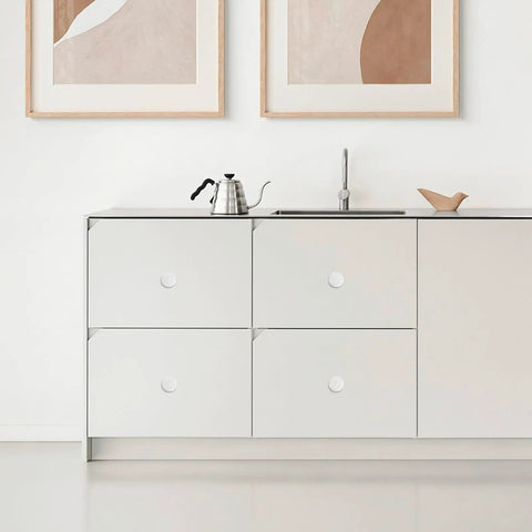 Minimalist kitchen with Retro Porcelain Cabinet Knobs And Drawer Pulls Set White Ceramic Kitchen Hardware installed on drawers.