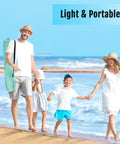 Family carrying Deluxe XL Pop Up Beach Tent Sun Shade For 3 To 4 People With UV Protection And Extendable Floor on a beach day