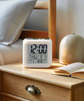 Solid Build Cube Digital Alarm Clock With Seven Color Led Night Light And Easy Peasy Snooze tracks time, date, and temperature on bedside.