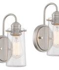 Kira Home Rayne 10" Modern Farmhouse Wall Sconce for Bathroom Vanity, Pack of 2 with brushed nickel finish and clear glass shade.
