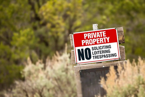 Tough As Nails Private Property No Trespassing Signs on wooden post, 10x14 inches, heavy duty aluminum, outdoor security.