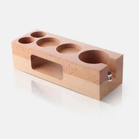 Premium 58 Mm Espresso Tamping Station Crafted From Warm Natural Wood showing a solid beech tamper holder with multiple holes.