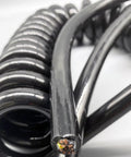 Built To Last Hardcore 12 Core Coiled Extension Cord featuring real copper wiring with black rip-proof cover and coiled design.