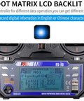 Close-up of Six Channel 2.4GHz RC Transmitter With FS-iA6 Receiver, featuring dot matrix LCD backlit screen, digital display.