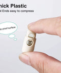 8 Pack Spring Cord Locks Plastic End Stopper Single Hole Toggle Fasteners For Drawstrings Shoelaces Tents And Tie Downs Beige Durable Quick Grip DIY Rope End Clips, beige plastic cord lock shown between fingers